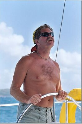 Caribbean Sailing Charters | Capt. Ray at the helm in British Virgin Islands